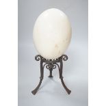 An ostrich egg on wrought iron stand, 29cm