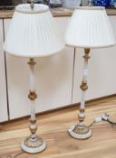 A pair of gilt and cream painted lamps, 83cm high