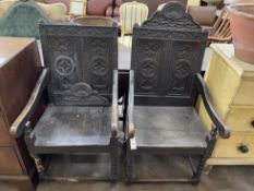 A pair of Victorian carved oak wainscot type chairs, width 56cm, depth 60cm, height 96cm