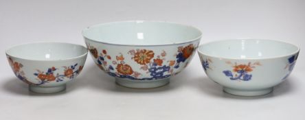 A graduated set of three Chinese Imari bowls, Qianlong period, hand painted with flowers, the