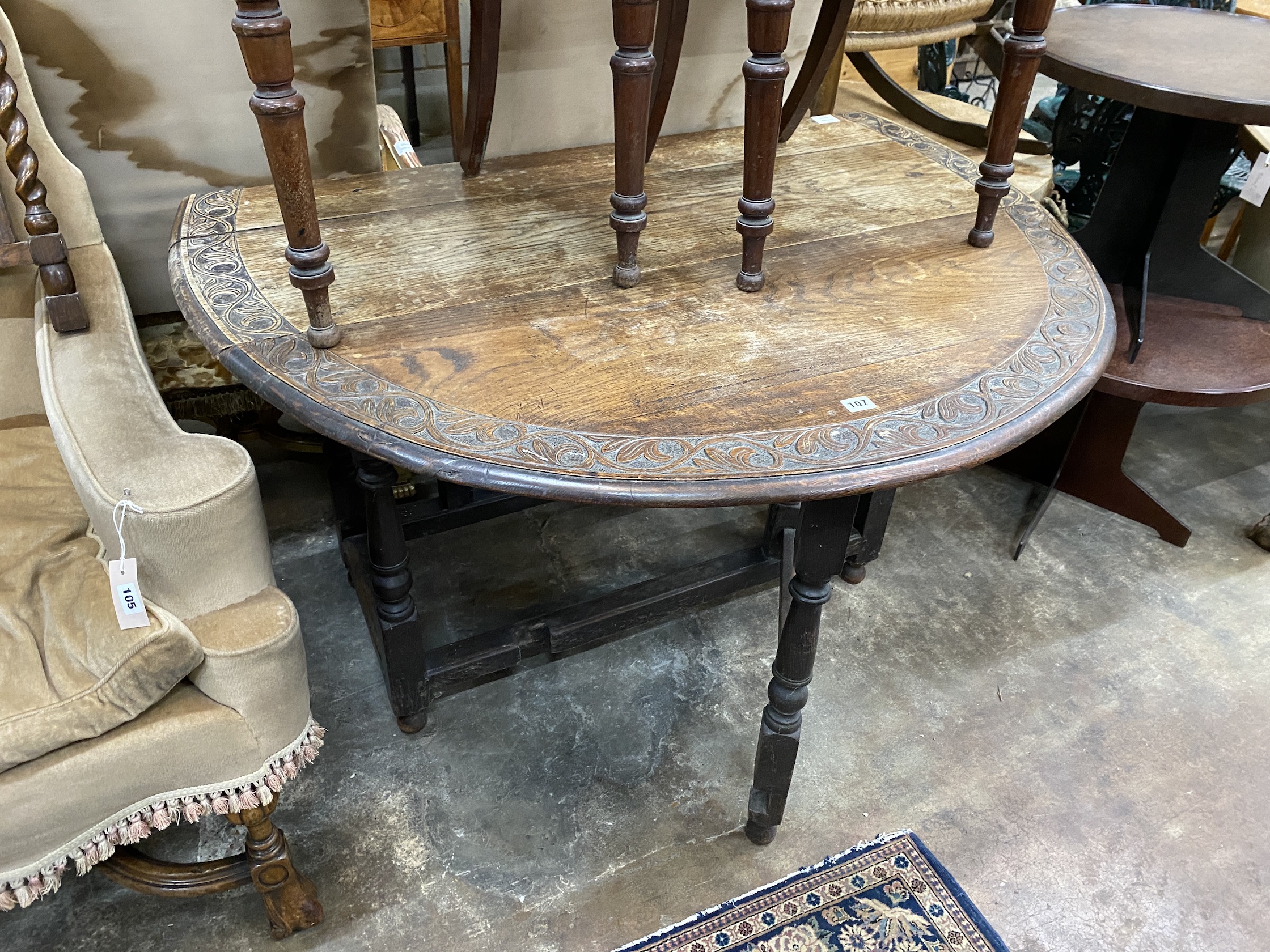 An early 20th century carved oak gateleg table, width 120cm, depth 44cm, height 74cm - Image 5 of 6