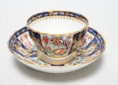 A Chamberlains Worcester good kakiemon style teabowl and saucer painted with oriental flowering