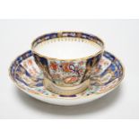 A Chamberlains Worcester good kakiemon style teabowl and saucer painted with oriental flowering