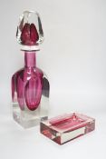A large oversized Murano studio glass tear drop perfume bottle and a cranberry ashtray, the