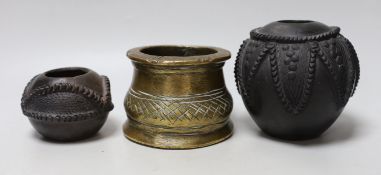An African bronze mortar and two pots with carved and incised decoration, the largest 12cm high