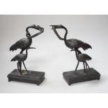 A pair of Japanese bronze crane figure groups, on later bases, 18cm high
