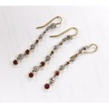 Three yellow metal and graduated ruby and diamond cluster set line drop earrings, overall 50mm,