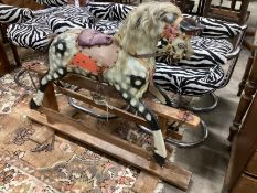 An early 20th century Collinson type dapple grey rocking horse on pine safety frame length 126cm,