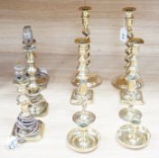 Four pairs of brass candlesticks, and another three converted to lamps, tallest 31cms high