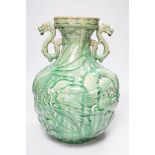 A Chinese green glazed vase with twin zoomorphic handles, decorated in relief with dragons, 35cm