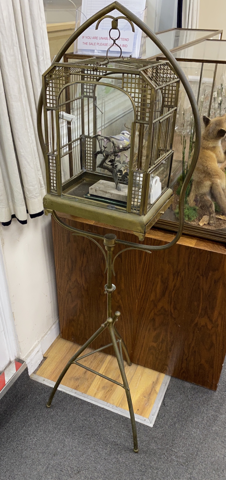 A 20th century French tubular brass glazed bird cage on tripod stand, height 152cm