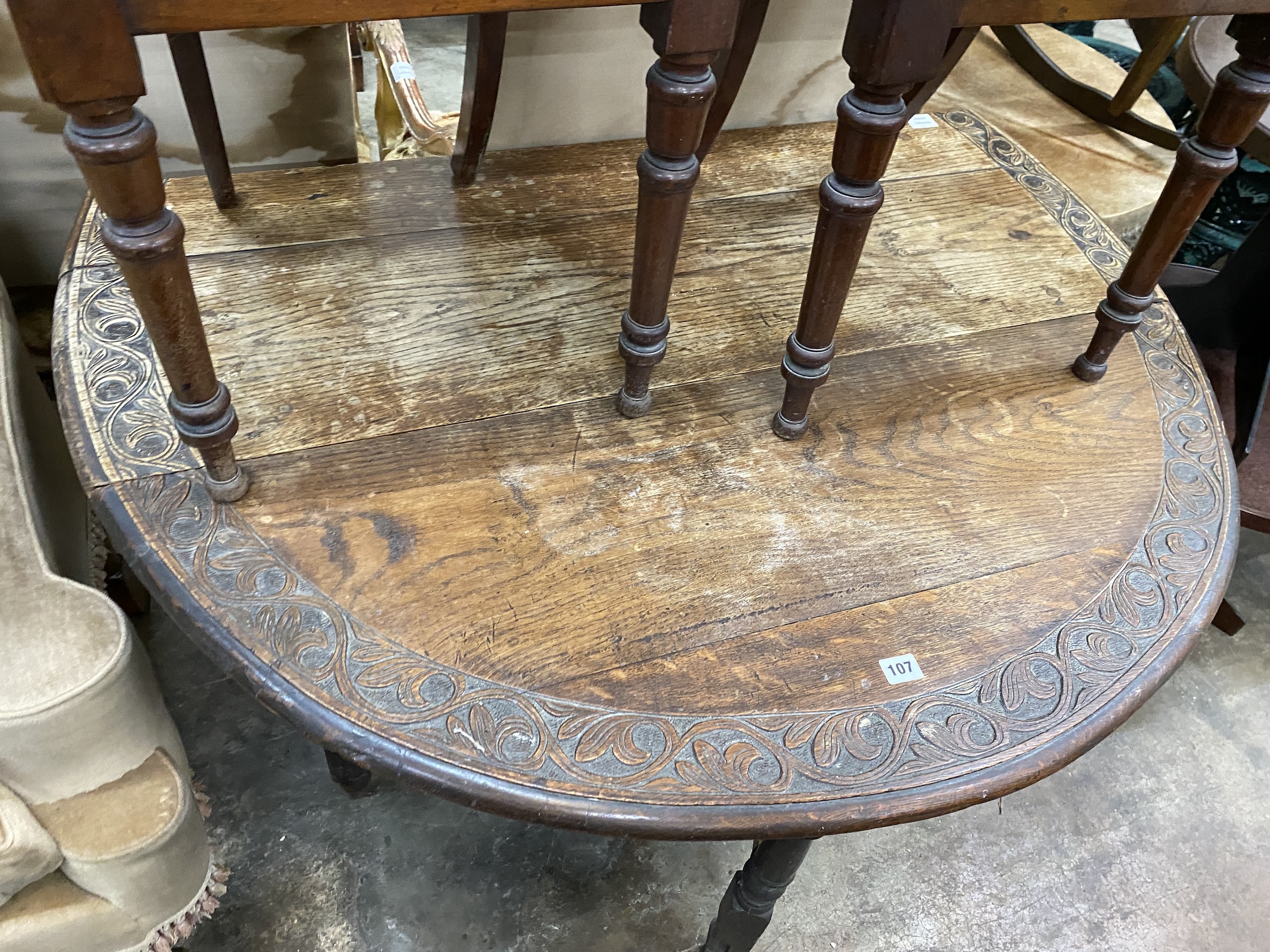 An early 20th century carved oak gateleg table, width 120cm, depth 44cm, height 74cm - Image 4 of 6