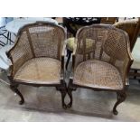 A pair of Queen Anne revival walnut cane seat tub framed bergere armchairs, width 55cm, depth