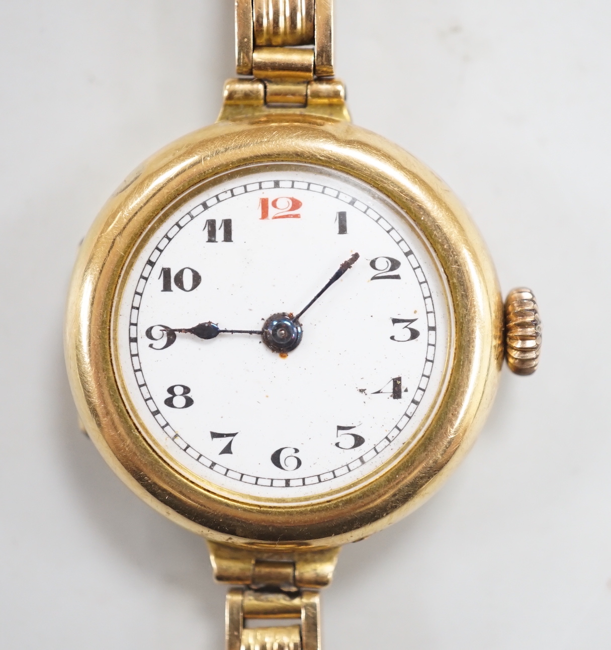 An early 20th century 18ct gold manual wind wrist watch, on an 18ct flexible bracelet, case diameter