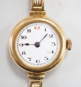 An early 20th century 18ct gold manual wind wrist watch, on an 18ct flexible bracelet, case diameter