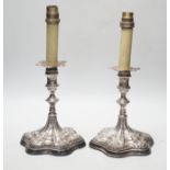 A pair of Georgian? silver candlesticks, on later wooden bases which have been drilled for