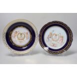 Two similar Sevres style plates hand painted with putti and gilded ivy leaf design border, each