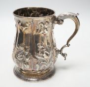 A George III silver baluster mug, with later embossed decoration, Joseph Steward?, London, 1763,
