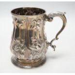 A George III silver baluster mug, with later embossed decoration, Joseph Steward?, London, 1763,