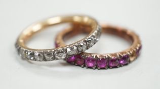 An antique yellow metal and diamond set full eternity ring (stone missing), size L and a similar