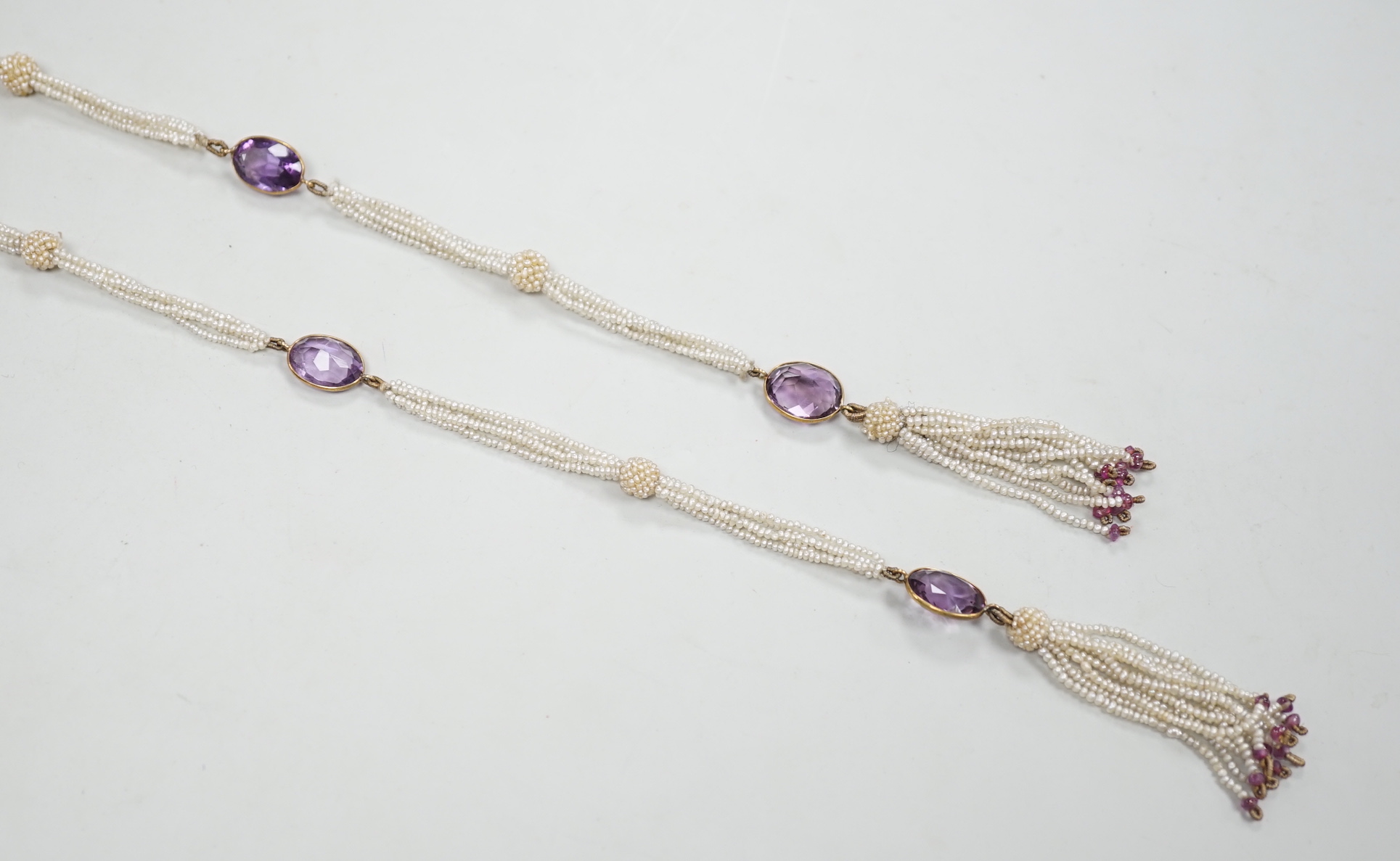 A 19th century Indian multi strand seed pearl and oval cut amethyst set long necklace, with gem