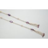 A 19th century Indian multi strand seed pearl and oval cut amethyst set long necklace, with gem