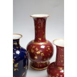 A pair of late 19th century French porcelain vases, and two others, tallest 25cm high