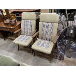 A pair of teak reclining garden elbow chairs with cushions, width 60cm, height 100cm