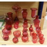Cranberry glassware including vases, jugs, bowls and custard cups, the largest 33cm high