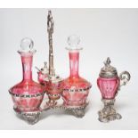 A plated cranberry two bottle and two cruet stand and a similar plated and cranberry mustard,