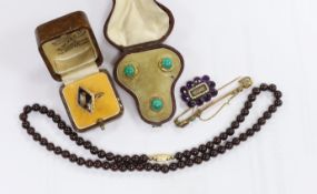 A Georgian amethyst paste and seed pearl set mourning brooch, with plaited hair, 27mm, a cased set
