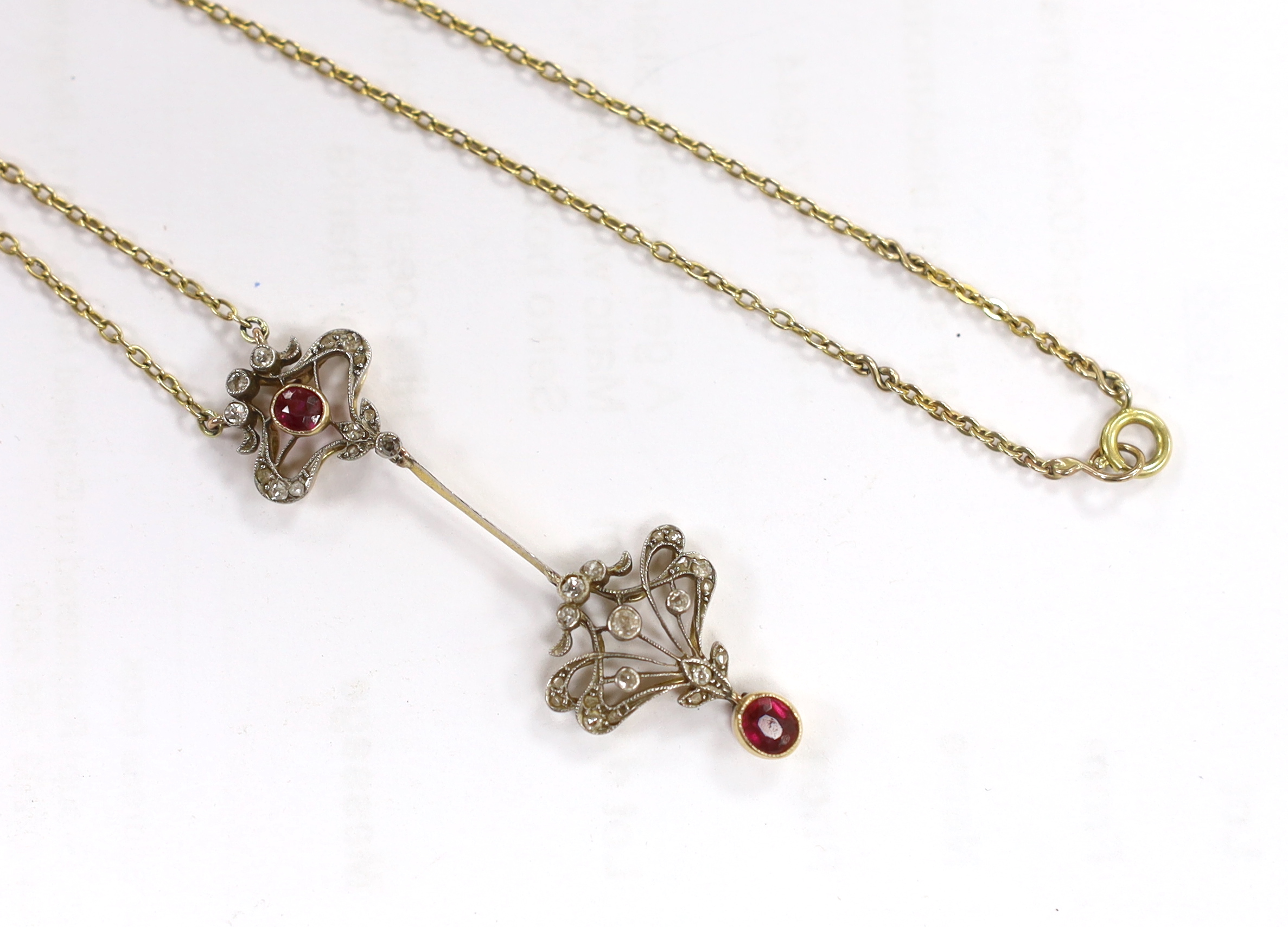 A Belle Epoque yellow metal and millegrain set ruby and diamond drop pendant necklace, the chain