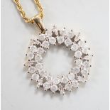A modern 9ct gold, baguette and round cut diamond cluster set openwork pendant, diameter 17mm, gross