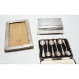 A set of six George VI silver teaspoons, Birmingham, 1939, cased, a silver cigarette box and a