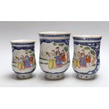 A graduated set of three Chinese mugs, Qianlong period, hand painted in the famille rose palette