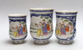 A graduated set of three Chinese mugs, Qianlong period, hand painted in the famille rose palette