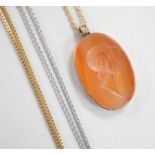 A yellow metal mounted oval intaglio carnelian stone, carved with the bust of gentleman to sinister,