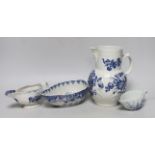An 18th century Worcester blue and white cabbage-leaf mask jug, two similar sauceboats and an 18th