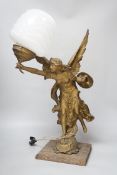 A gilt spelter Victory figural lamp with opaque glass shade, raised on a square base, 54cm high