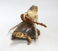 A taxidermic model of a guitar strumming toad riding a terrapin, 12cm