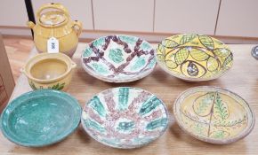 A group of Mediterranean slip decorated pottery dishes, a jar and cover and a bowl, predominantly