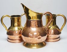 A pair late 19th century copper and brass twin handled vases and a similar jug, the largest 35cm