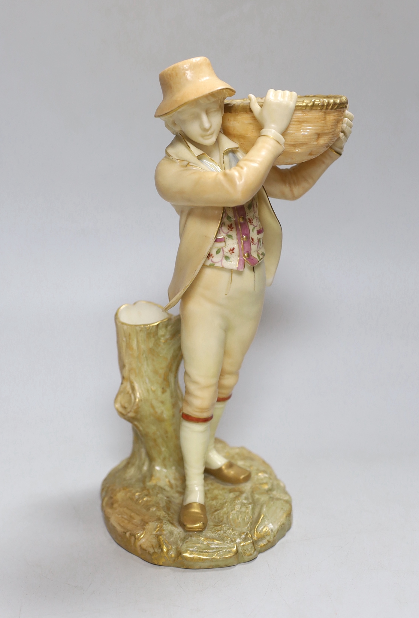 A Royal Worcester figure of a boy, highlighted in gold, with a wicker basket in his hands, painted