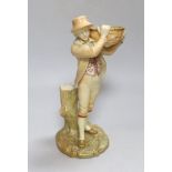 A Royal Worcester figure of a boy, highlighted in gold, with a wicker basket in his hands, painted