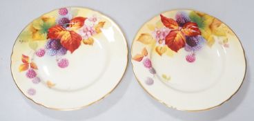 A pair of Royal Worcester lobed tea plates painted with autumnal leaves and berries by Kitty