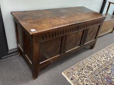 A late 17th century oak coffer, with a triple lozenge carved panelled front, width 133cm, depth