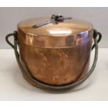 A French copper cooking pot and cover with swing handle, 27cm high