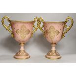 A pair of large Coalport salmon pink ground two handled loving cups, 28.5cm