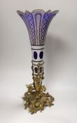 A 19th century Bohemian overlaid glass trumpet vase, on an ornate gilt metal stand, 44cm high