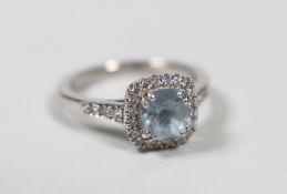 A modern 18ct white gold, aquamarine and diamond set square cluster ring, size J, gross weight 3.4